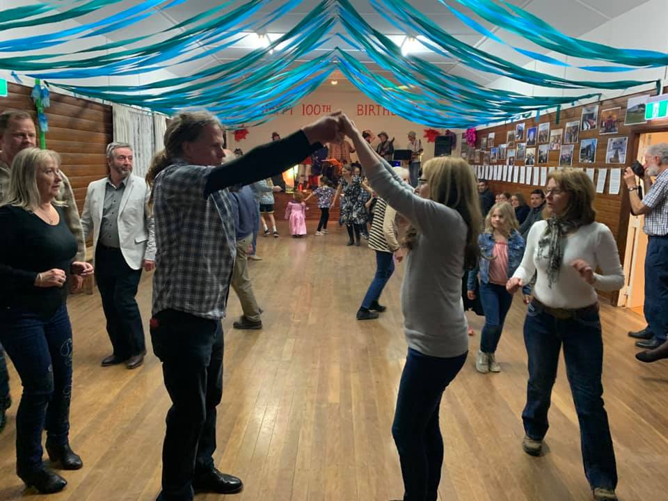 view through dancers making an arch - looking towards band