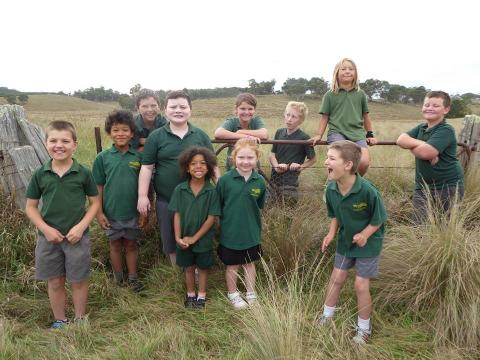 image of students posing in long grass