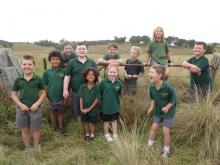 image of students posing in long grass